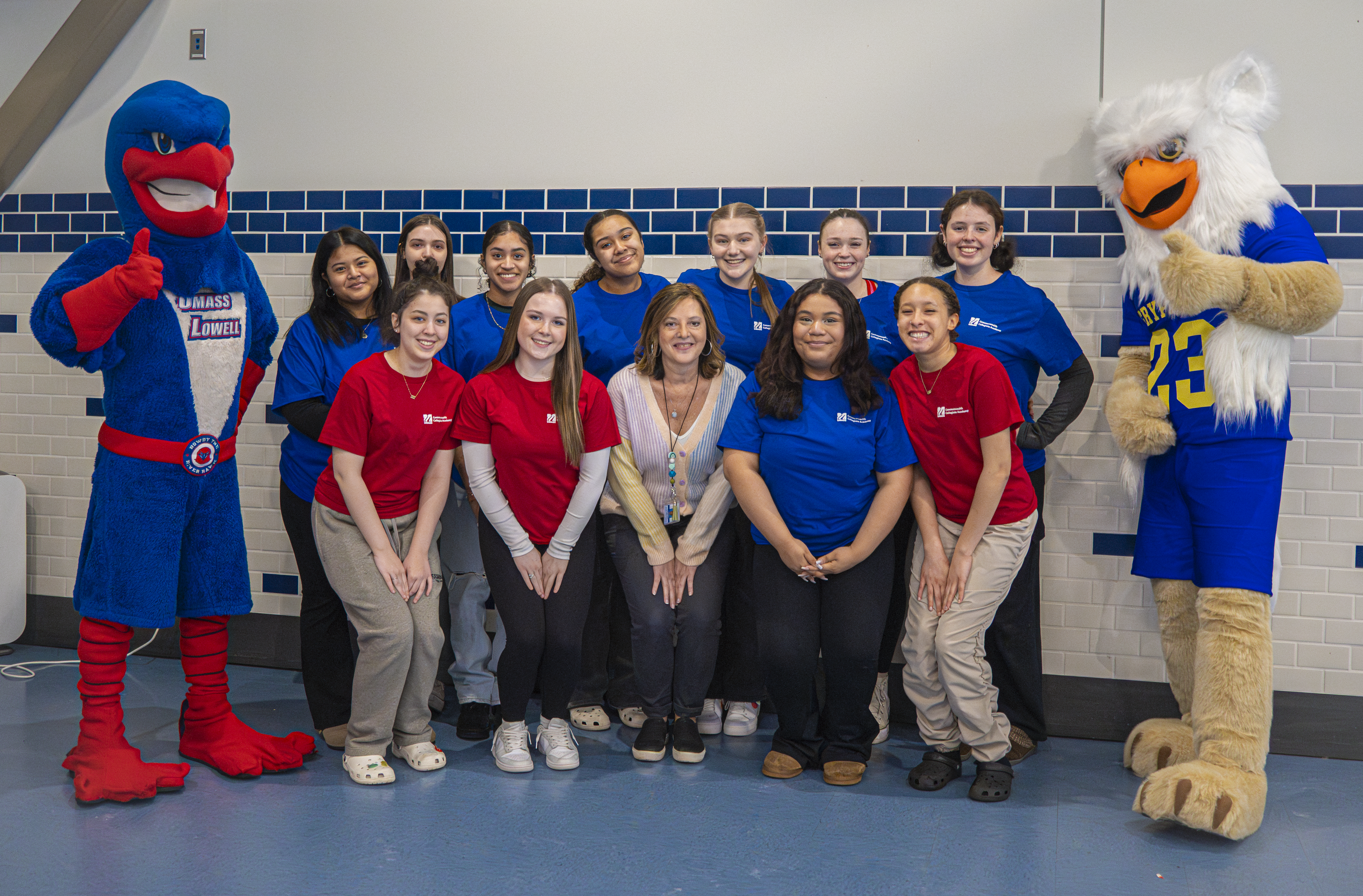 Students in the program pose for a picture with the mascots of both UMass Lowell and Greater Lowell Technical Highschool