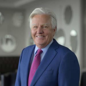 marty meehan, a light-skinned, older gentleman with white hair in a dark suit, white shirt and turquoise neck tie